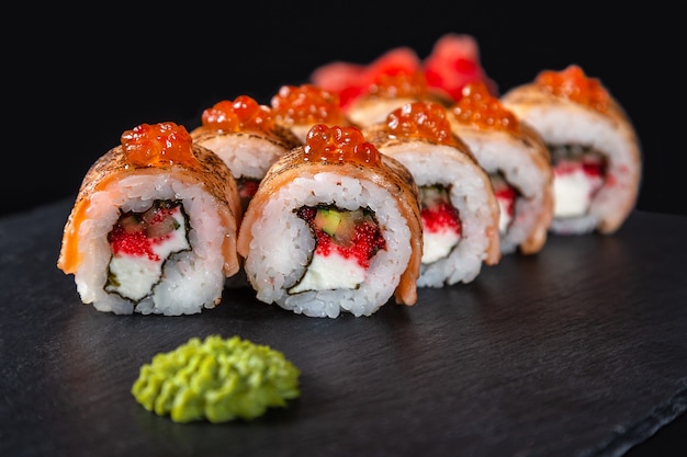 set-of-sushi-rolls-on-black-background_78790-986